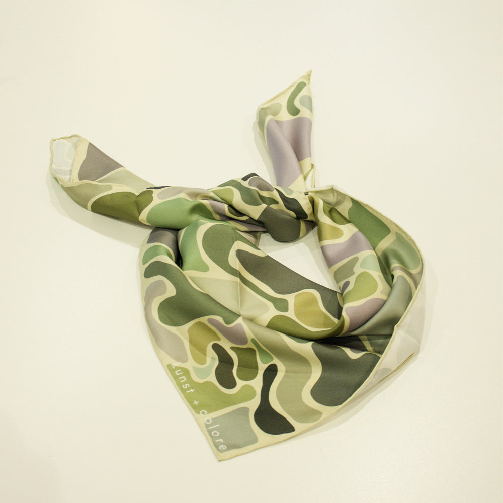 'Call It Camo' scarf in mint by Kunst & Colore. Mint background with lilac, blue, green organic forms, tied into a neck scarf.