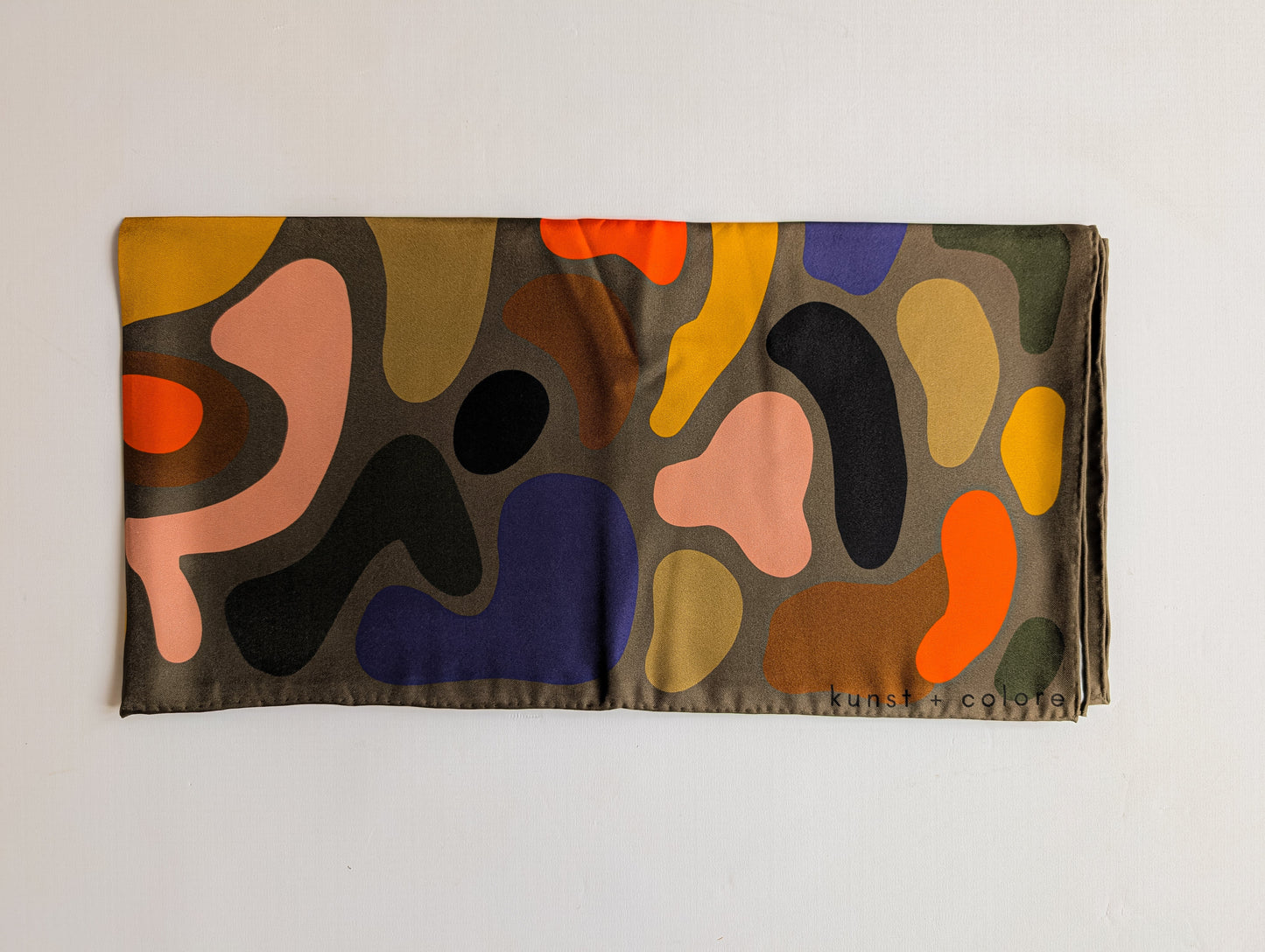 Colorful abstract patterned scarf on a white background