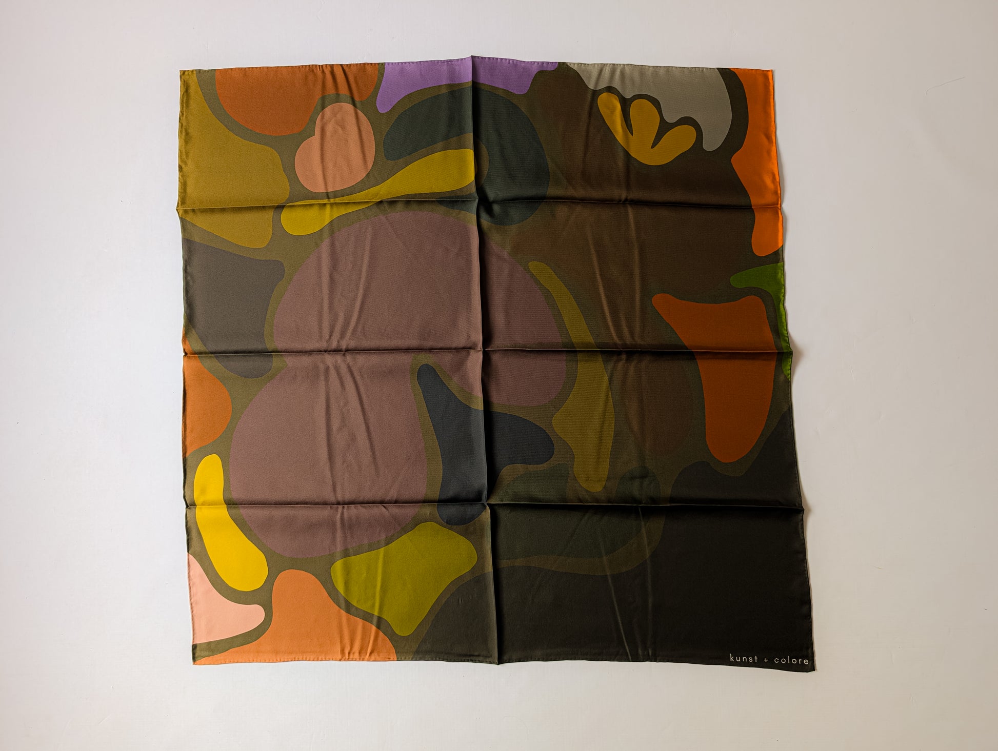 Colorful abstract print silk scarf on a white background