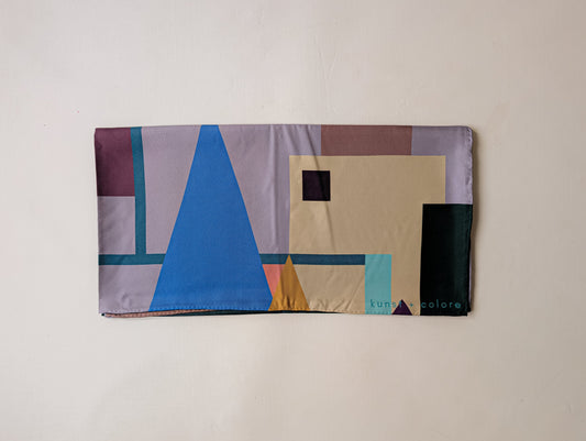 Folded silk scarf with geometric pattern on a beige background